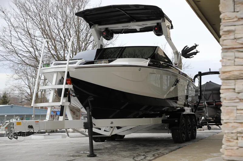 Slide: The Image of 2026 Centurion Ri245 boat on trailer, parked outdoors near building. - 5