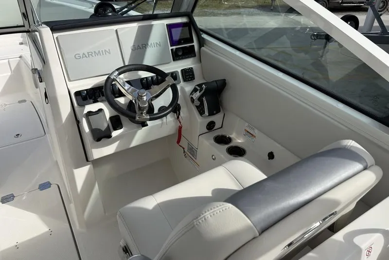 Slide: The Image of 2026 Sailfish 276 DC boat cockpit with Garmin navigation system and steering wheel. - 12
