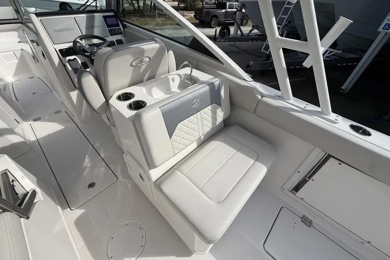 Slide: The Image of 2026 Sailfish 276 DC boat interior with modern seating and Garmin navigation system. - 16
