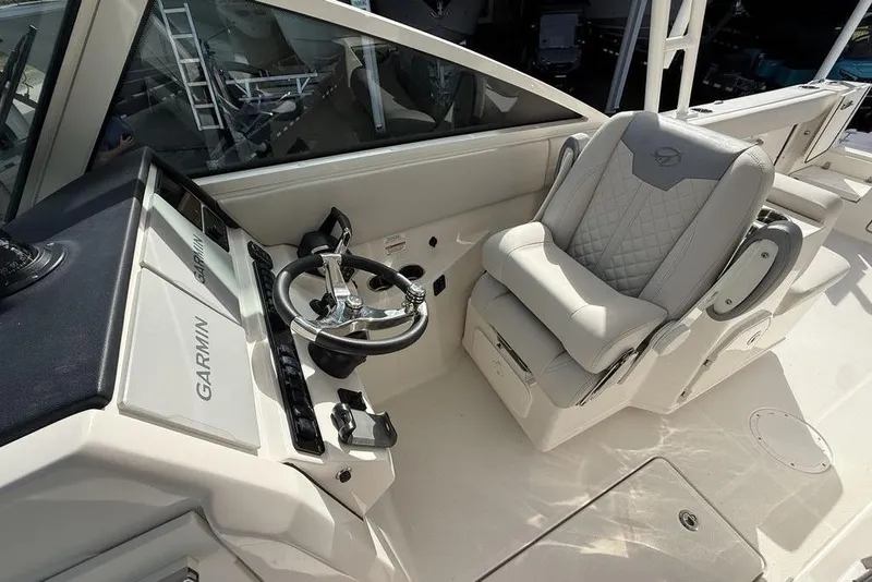 Slide: The Image of 2026 Sailfish 276 DC boat cockpit with Garmin navigation and luxurious seating. - 18