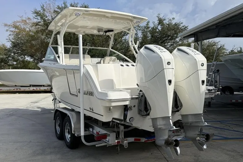 Slide: The Image of 2026 Sailfish 276 DC boat with dual outboard engines on a trailer. - 8