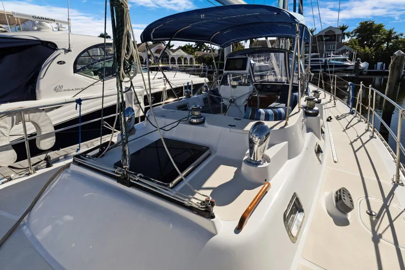 Slide: The Image of 2009 Hylas 46 yacht docked, featuring sleek design and spacious deck layout. - 10