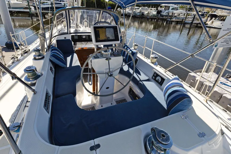 Slide: The Image of 2009 Hylas 46 sailboat cockpit with blue seating and navigation equipment. - 13