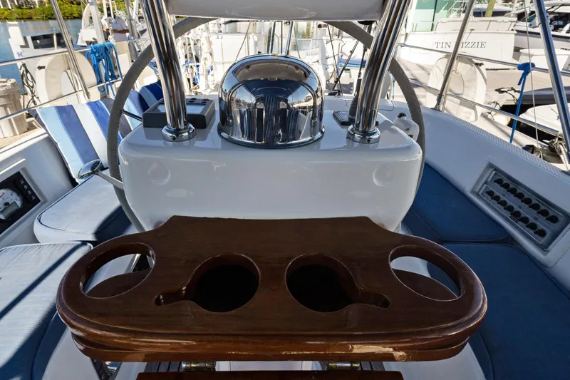 Slide: The Image of Cockpit of 2009 Hylas 46 yacht with wooden cup holders and blue seating. - 16