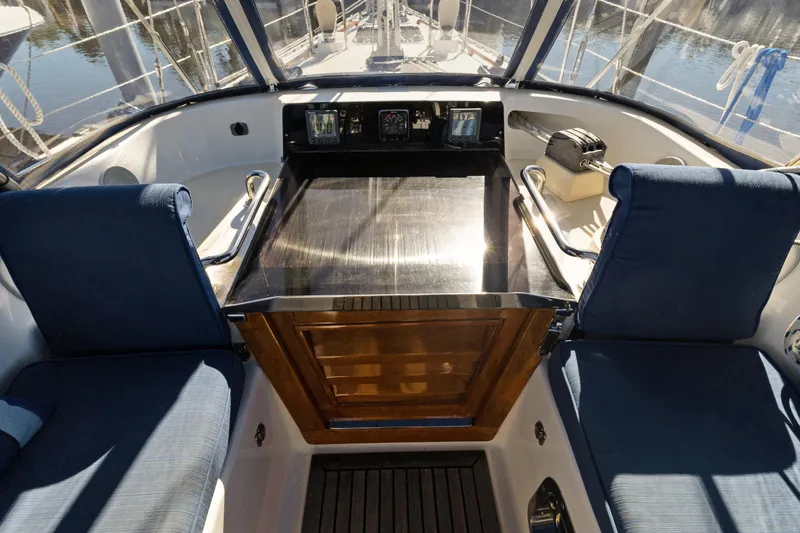 Slide: The Image of Cockpit of 2009 Hylas 46 sailboat with blue seating and navigation instruments. - 17