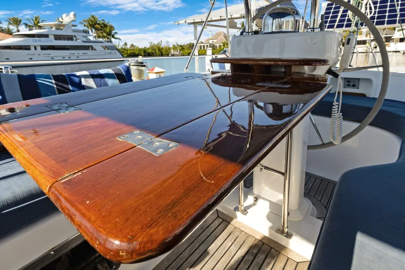 Slide: The Image of Polished wooden table on 2009 Hylas 46 yacht deck, with marina view. - 18