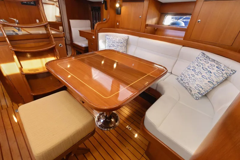 Slide: The Image of Luxurious 2009 Hylas 46 yacht interior with polished wood table and white seating. - 28