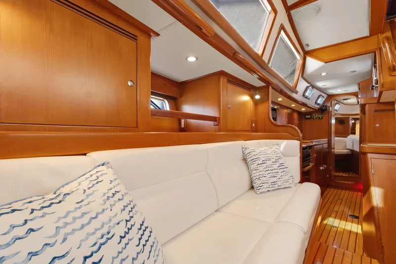 Slide: The Image of Luxurious interior of 2009 Hylas 46 yacht with white seating and wooden cabinetry. - 30