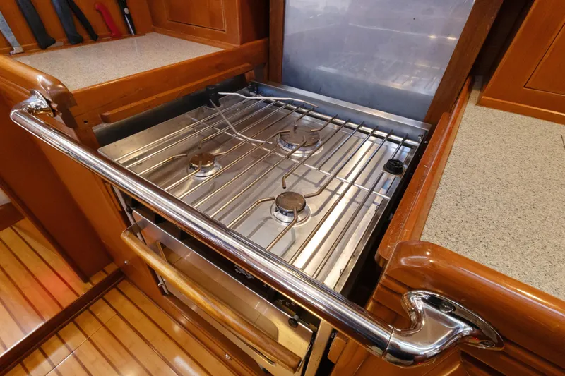 Slide: The Image of Stainless steel stove in 2009 Hylas 46 yacht kitchen, featuring wooden cabinetry and countertops. - 36