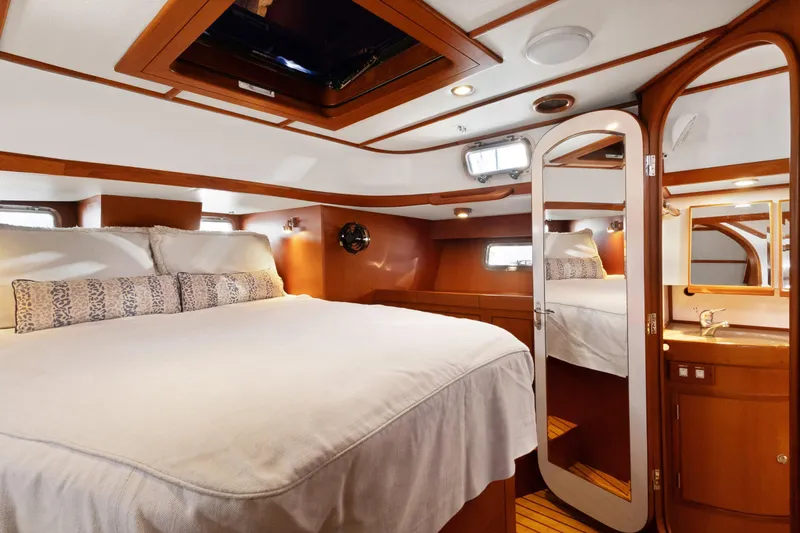 Slide: The Image of Luxurious cabin interior of 2009 Hylas 46 yacht with elegant wood finish and cozy bedding. - 39