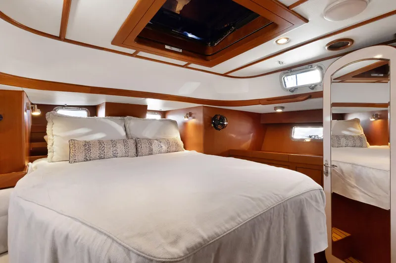 Slide: The Image of Luxurious cabin interior of 2009 Hylas 46 yacht with cozy bedding and elegant wood finish. - 40