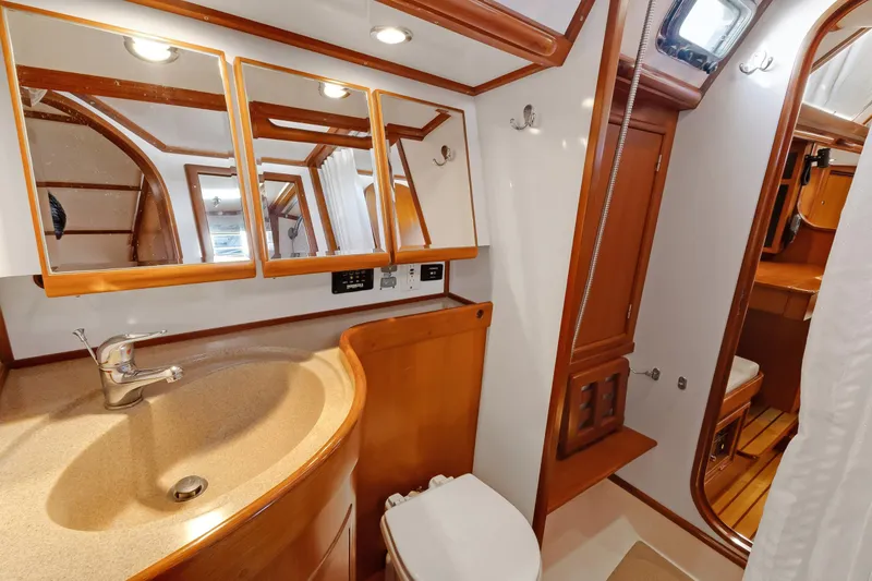 Slide: The Image of Luxurious 2009 Hylas 46 yacht bathroom with wooden accents and modern fixtures. - 44