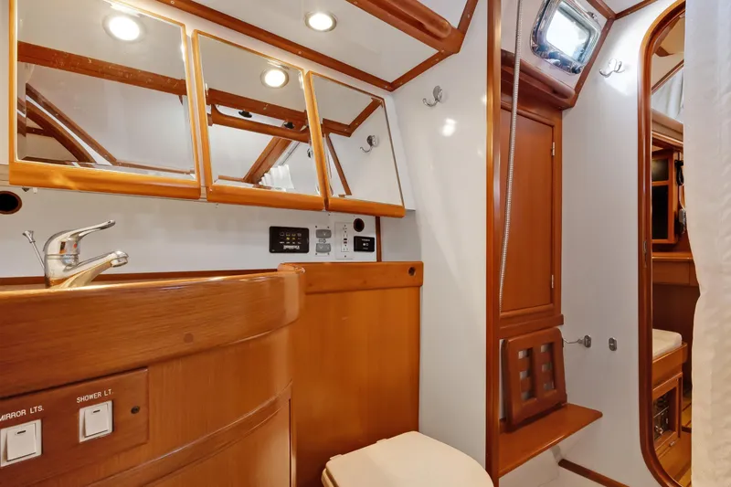 Slide: The Image of Luxurious 2009 Hylas 46 yacht bathroom with wooden cabinetry and modern fixtures. - 45