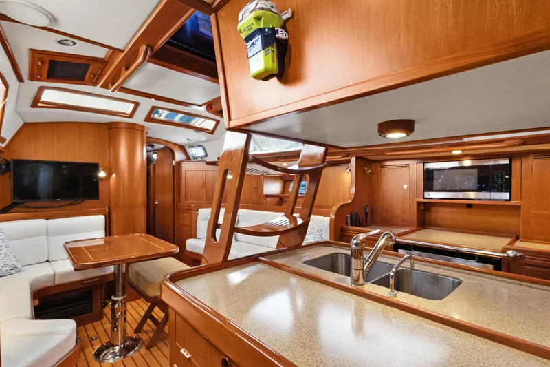 Slide: The Image of Luxurious interior of a 2009 Hylas 46 yacht with wood finishes and modern amenities. - 46