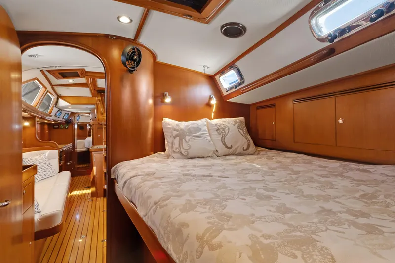 Slide: The Image of Luxurious 2009 Hylas 46 yacht interior with cozy bedroom and elegant wood finish. - 48