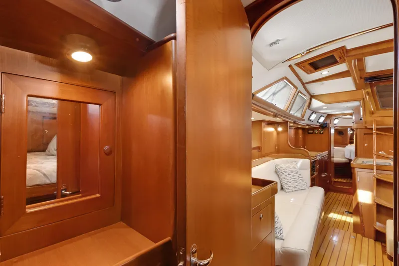 Slide: The Image of Luxurious interior of a 2009 Hylas 46 yacht with wood finishes and cozy seating. - 49