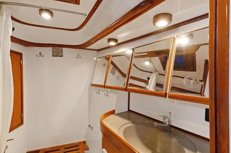 Slide: The Image of Luxurious 2009 Hylas 46 yacht bathroom with wooden accents and modern fixtures. - 51
