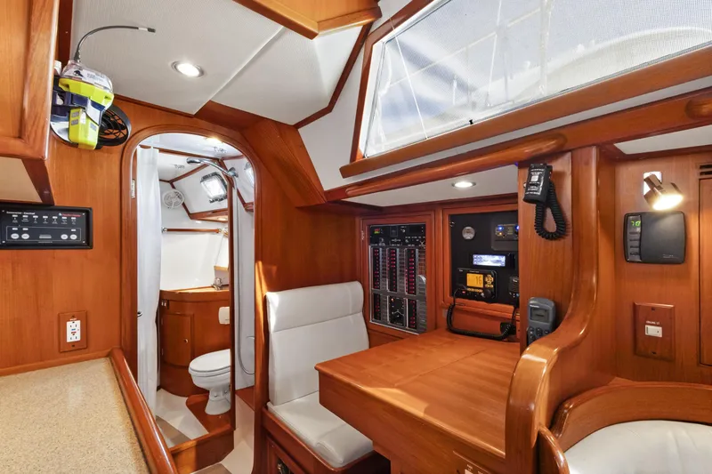 Slide: The Image of Interior of 2009 Hylas 46 yacht featuring navigation station and bathroom. - 54