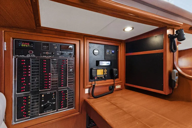 Slide: The Image of Control panel of a 2009 Hylas 46 yacht, featuring navigation and communication equipment. - 56