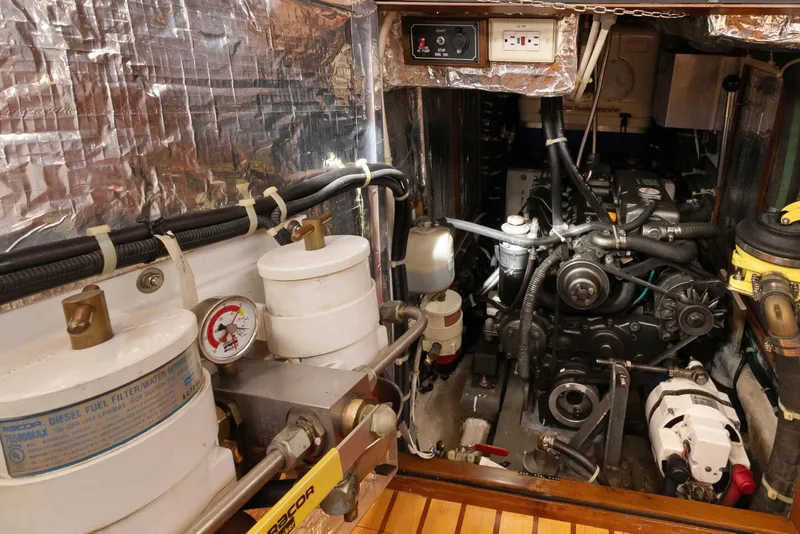 Slide: The Image of Engine room of a 2009 Hylas 46 yacht, featuring diesel fuel filters and mechanical components. - 60