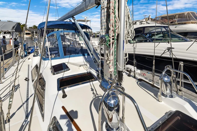 Slide: The Image of 2009 Hylas 46 sailboat docked, showcasing deck and rigging details. - 8