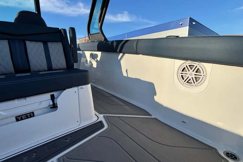 Slide: The Image of 2026 Monterey Elite 30 OB boat interior with seating and speaker detail. - 11