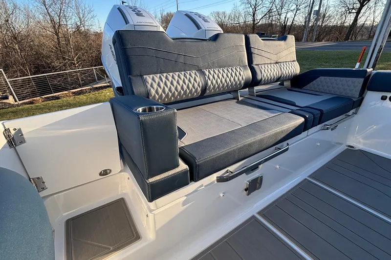 Slide: The Image of 2026 Monterey Elite 30 OB boat interior with luxurious seating and cup holder. - 16