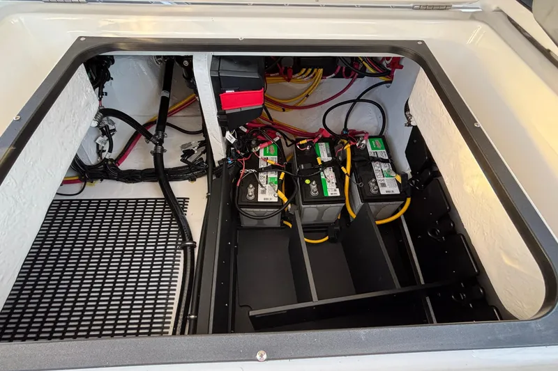 Slide: The Image of 2026 Monterey Elite 30 OB boat battery compartment with wiring and storage. - 18