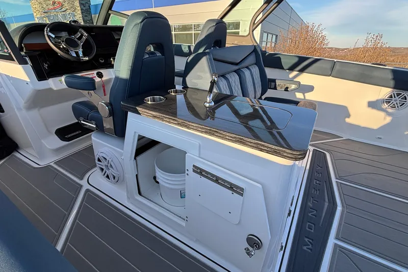 Slide: The Image of 2026 Monterey Elite 30 OB boat interior with sleek seating and modern dashboard. - 21