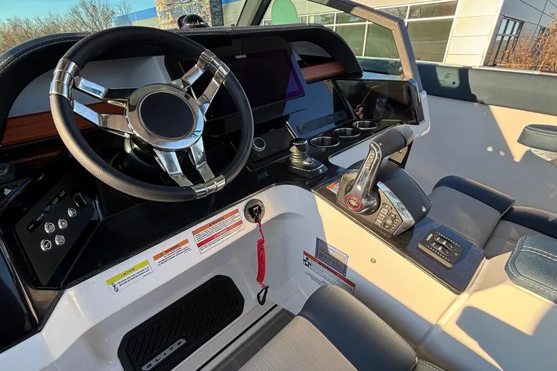 Slide: The Image of 2026 Monterey Elite 30 OB boat cockpit with modern steering and controls. - 23