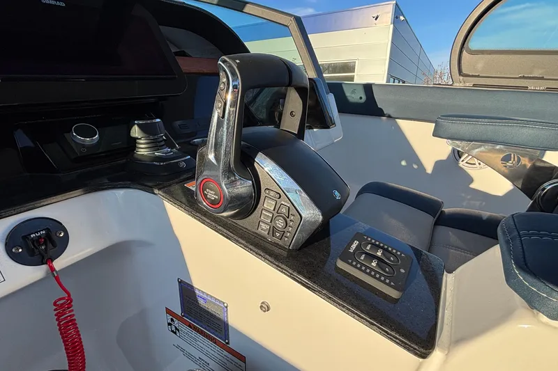 Slide: The Image of Control panel of 2026 Monterey Elite 30 OB boat with throttle and navigation controls. - 24