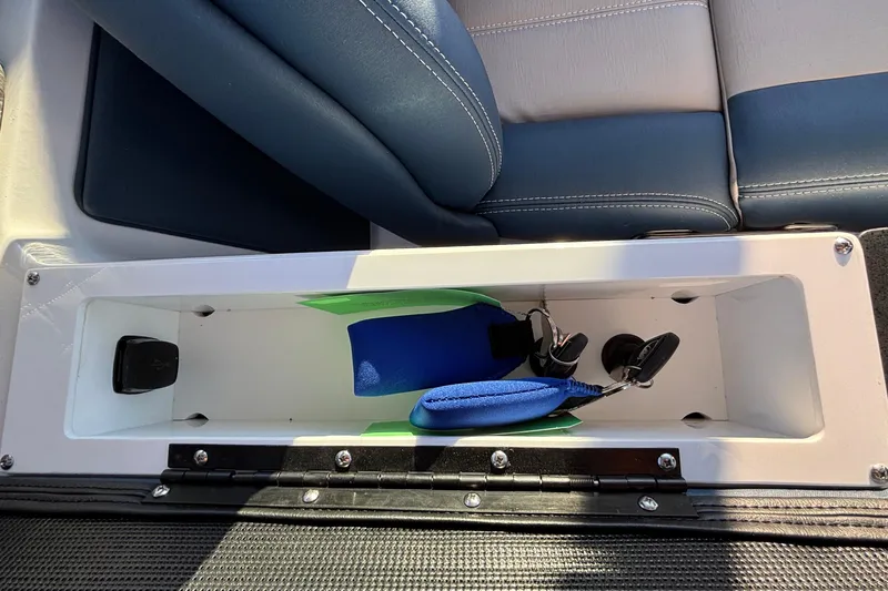 Slide: The Image of 2026 Monterey Elite 30 OB storage compartment with blue and green accessories. - 25