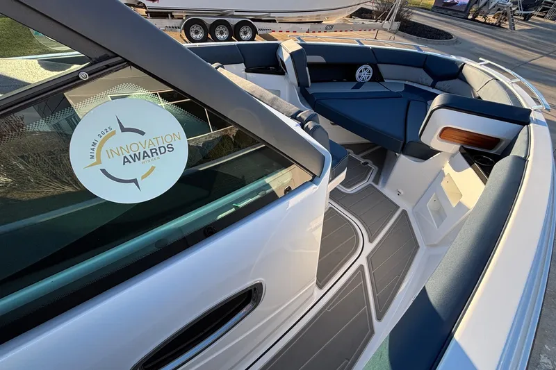 Slide: The Image of 2026 Monterey Elite 30 OB boat interior with award sticker, showcasing modern seating and design. - 27