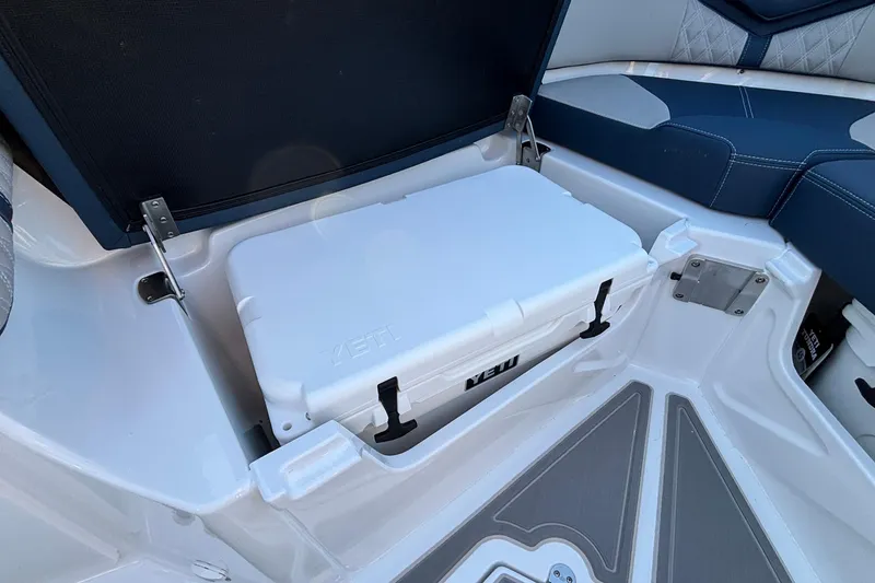 Slide: The Image of Open storage compartment with Yeti cooler on 2026 Monterey Elite 30 OB boat. - 33