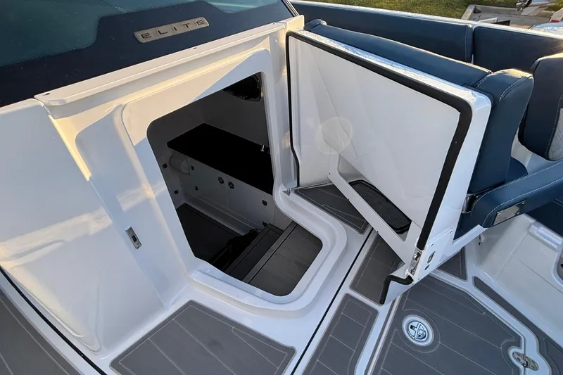 Slide: The Image of 2026 Monterey Elite 30 OB boat interior with open cabin door and seating area. - 35