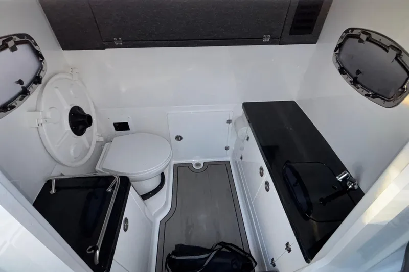 Slide: The Image of 2026 Monterey Elite 30 OB boat interior with toilet and sink, featuring modern design. - 37
