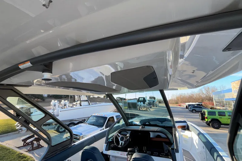 Slide: The Image of 2026 Monterey Elite 30 OB boat interior with steering wheel and dashboard view. - 40
