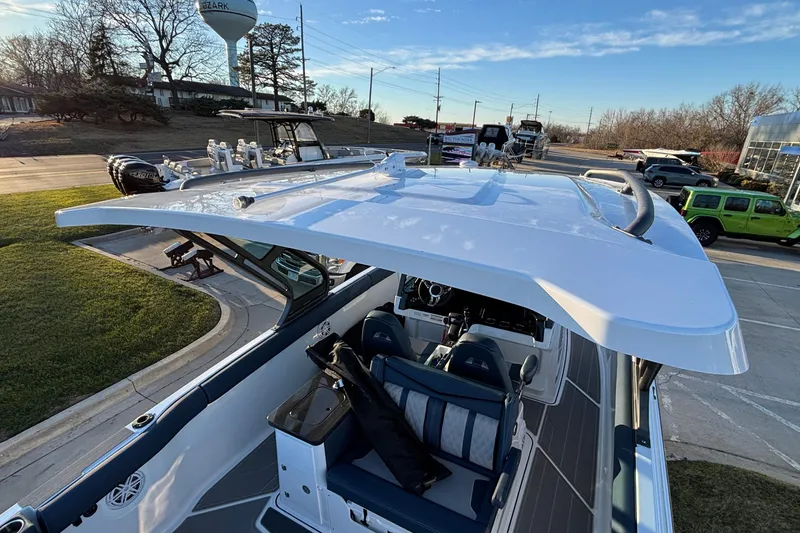 Slide: The Image of 2026 Monterey Elite 30 OB boat with sleek design and modern features, parked outdoors. - 42