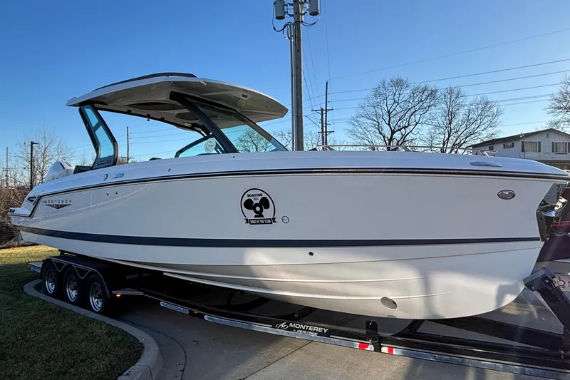 Slide: The Image of 2026 Monterey Elite 30 OB boat on trailer, side view, outdoors. - 43