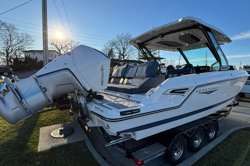 Slide: The Image of 2026 Monterey Elite 30 OB boat with Mercury outboard engine on a trailer, sunny day. - 45