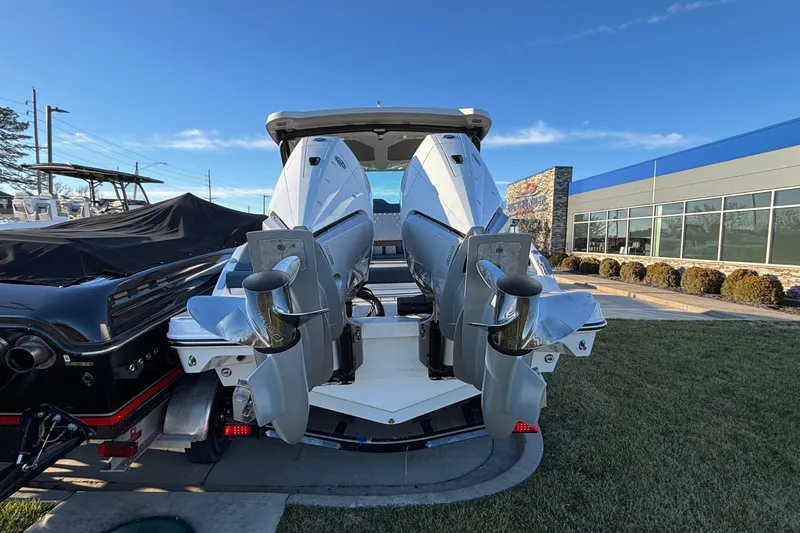 Slide: The Image of 2026 Monterey Elite 30 OB boat with dual outboard engines, displayed outdoors. - 46