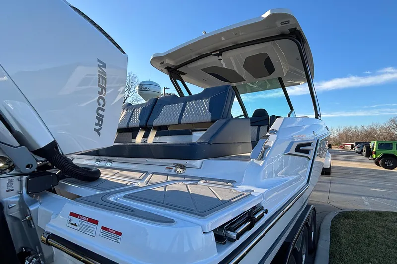 Slide: The Image of 2026 Monterey Elite 30 OB boat with Mercury engine, docked under clear blue sky. - 48