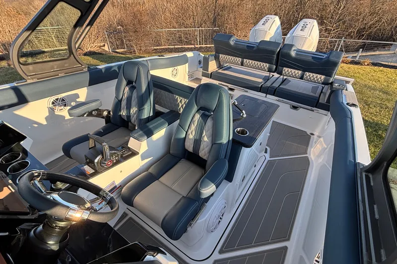 Slide: The Image of 2026 Monterey Elite 30 OB boat interior with luxurious seating and dual outboard engines. - 5