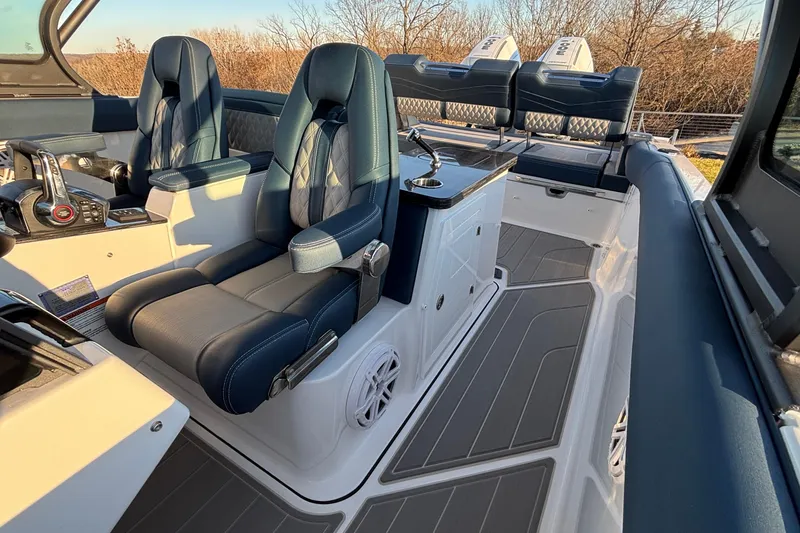 Slide: The Image of 2026 Monterey Elite 30 OB boat interior with luxurious seating and modern controls. - 6