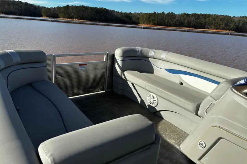 Slide: The Image of 2023 Bennington 22 SSR pontoon boat interior with lake view and comfortable seating. - 10