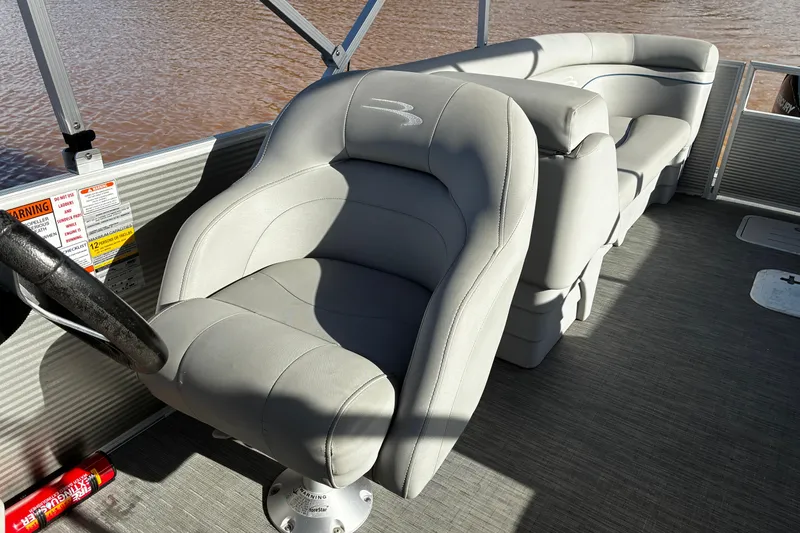 Slide: The Image of 2023 Bennington 22 SSR pontoon boat interior with plush seating and steering wheel. - 12