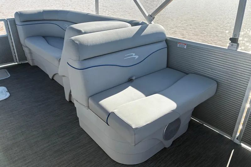 Slide: The Image of 2023 Bennington 22 SSR pontoon boat interior with gray seating and blue accents. - 13