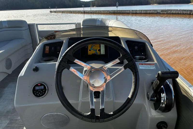 Slide: The Image of 2023 Bennington 22 SSR boat dashboard with steering wheel and navigation system. - 8