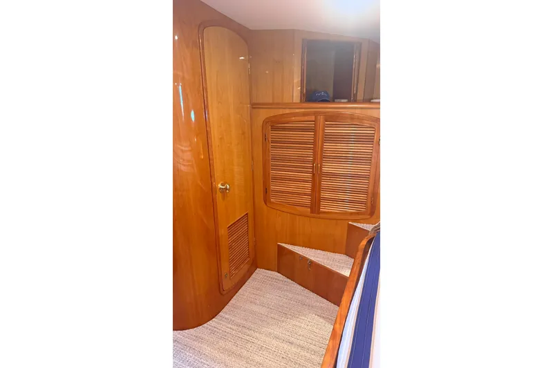 Slide: The Image of Interior of 2003 Mikelson 50 yacht with wooden cabinetry and carpeted flooring. - 12