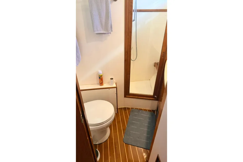 Slide: The Image of Bathroom in 2003 Mikelson 50 yacht with shower and wooden flooring. - 16